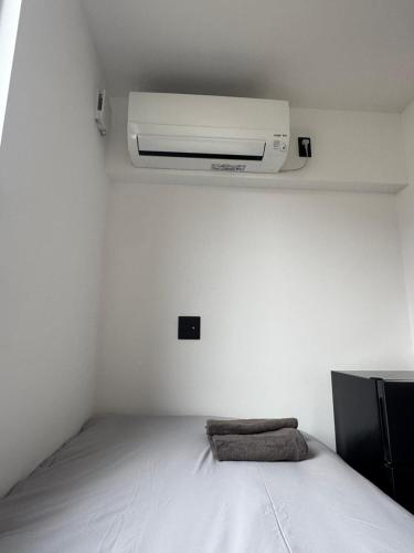 a bedroom with a bed with a air conditioner on the ceiling at MOD 02 Kutchan Stylish Commons - NO PARKING 駐車場なし in Kutchan