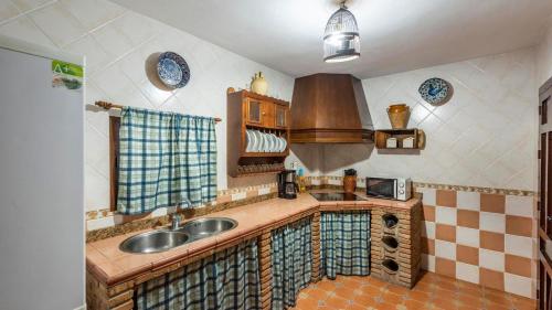a kitchen with a sink and a counter top at Cortijo El Llano Priego de Córdoba by Ruralidays in Priego de Córdoba