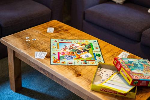 a wooden table with a board game on it at Cartref in Wales