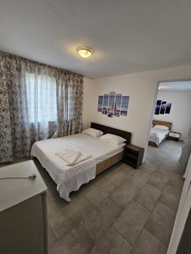 a bedroom with a large bed and a window at Sunshine Costinești in Schitul