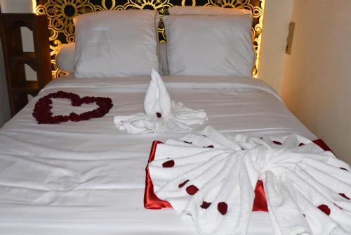 a bed with two towels and a heart on it at Riad Elijah and Spa Marrakech in Marrakech