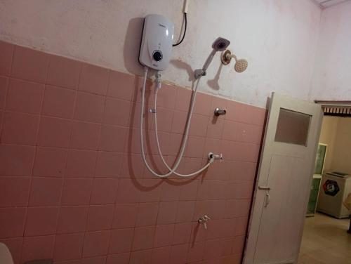 a shower in a bathroom with a camera on the wall at Kenashi Green Villa in Weligama