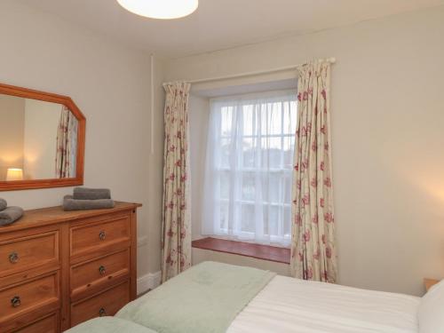a bedroom with a bed and a dresser and a window at Beck View in Pickering