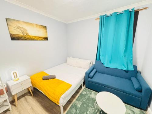 a small bedroom with a bed and a chair at London Budget-Friendly Stay in London