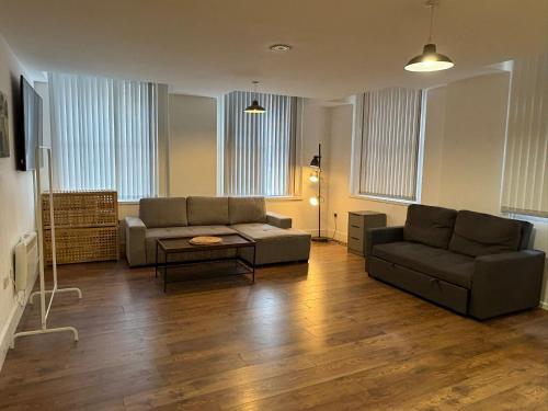 a living room with a couch and a table at The Cavern Quarter Aparthotel by UStay in Liverpool