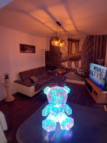 a living room with a teddy bear light on the floor at T2 Cosy autonome h24 Parking privé attenant TV 165cm Netflix wi-fi au Rez-de-chaussée in Alençon
