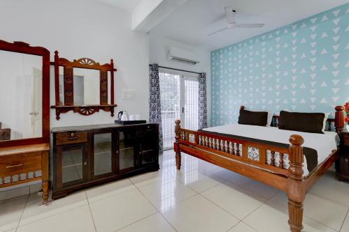 Un dormitorio con una cama, un lavabo y un espejo. en Collection O Sunrise Point Serenity Beach Formerly White Lotus Residency, en Kottakupam
