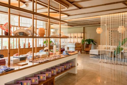 a store with wooden ceilings and a large glass wall at Zel Punta Cana - All Suites in Punta Cana