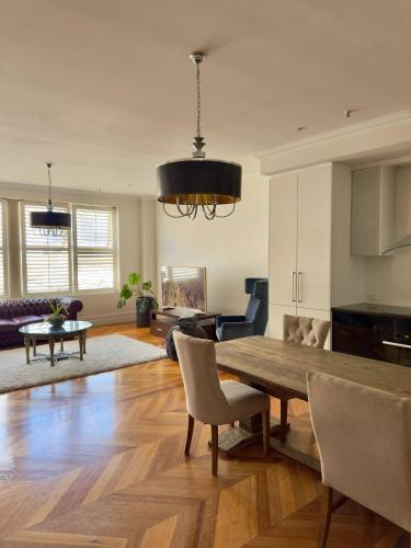a living room with a wooden table and a dining room at King Street Retreat in Perth