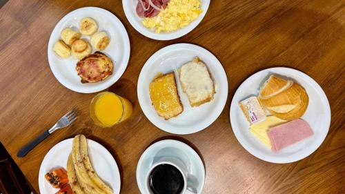 un tavolo con sopra piatti di cibo per la colazione di Manacá Hotel a Foz do Iguaçu