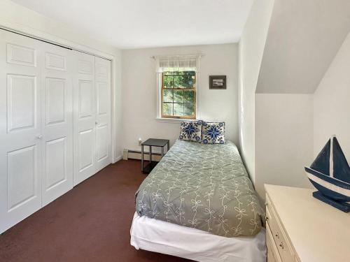 a small bedroom with a bed and a window at Family Retreat at York Beach in York