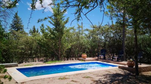 Cabañas Ayllu في لاس رابوناس: مسبح في ساحه فيها اشجار