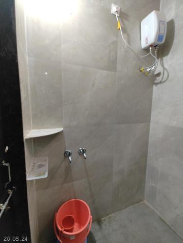 a shower stall with a toilet in a bathroom at Aadishkti bhakt nivas only for family in Tuljapur
