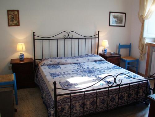 a bedroom with a bed and two tables and two lamps at Casa PAGLIERA in Porto San Giorgio