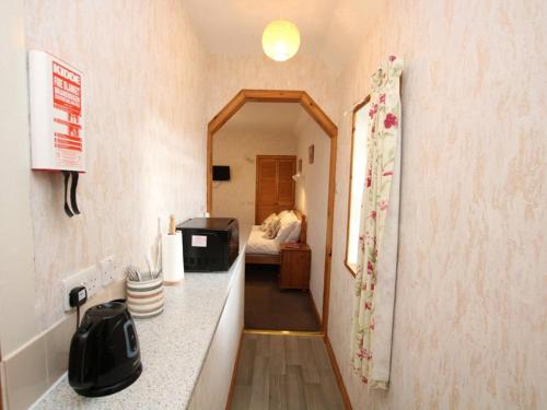 a room with a counter and a bedroom with a bed at Orkney Studio Holidays in Kirkwall