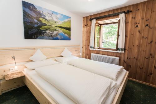 a bedroom with a bed in a wooden wall at Ferienhaus zur Hackenschmiede in Mauterndorf