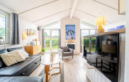 a living room with a couch and a table at Friedrichskoog-Deichblick 16 in Friedrichskoog
