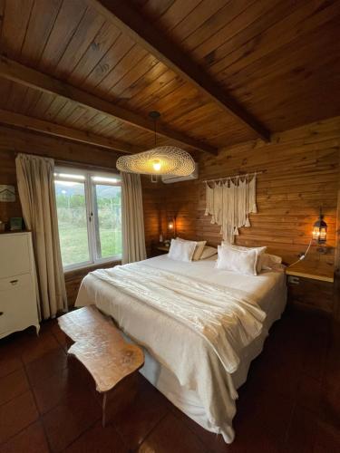 a bedroom with a large bed in a wooden room at Complejo El Yanten in Villa Ventana