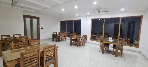 a dining room with wooden tables and chairs at The Trishul Vista in Mukteshwar