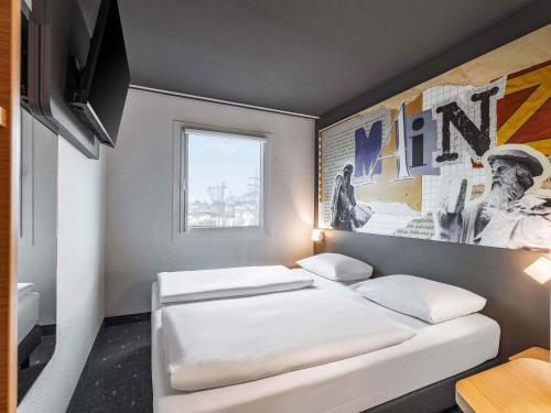 Postel nebo postele na pokoji v ubytování B&B HOTEL Mainz-Süd