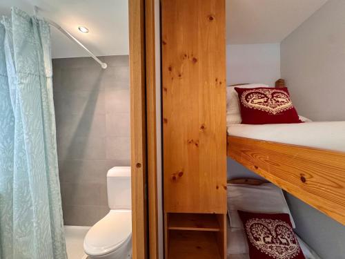 a bedroom with a bunk bed with a toilet and a shower at Lac & Love - Alpine Escape in Crans-Montana