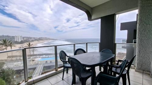 a balcony with a table and chairs and a view of the beach at Seagull 505 in Margate