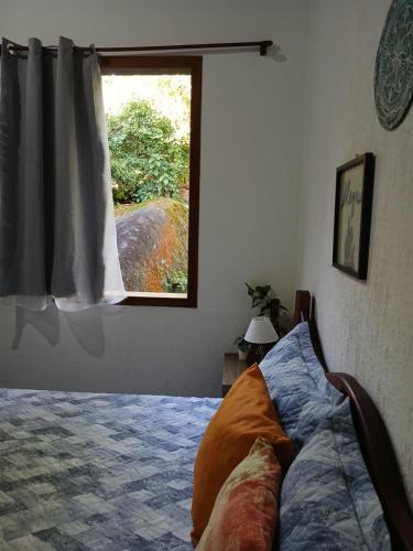 En eller flere senge i et værelse på Entre Árvores Hoosts Confort