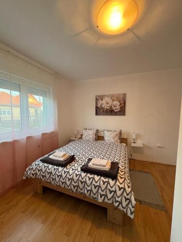 a bedroom with a bed in a room at Apartman Tijana in Ruma