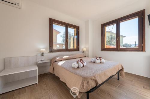 En eller flere senge i et værelse på Villa Monica