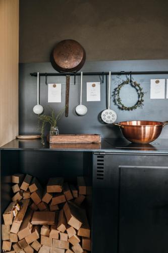 a kitchen with a counter with a bunch of wood at Ferienhaus Halwina hideaway in Sibratsgfäll
