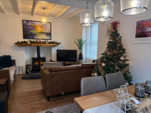 a living room with a christmas tree and a couch at Family Cottage in Llandudno with Parking in Llandudno