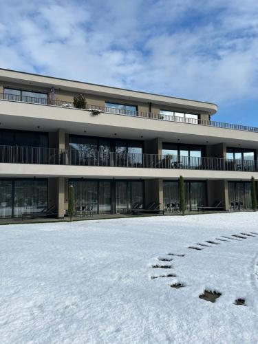 a building with snow in front of it at Belia Lofts - ADULTS ONLY - Apartments in Appiano sulla Strada del Vino