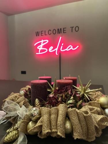 a table with a welcome to belita sign in the background at Belia Lofts - ADULTS ONLY - Apartments in Appiano sulla Strada del Vino