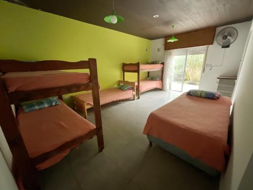 a room with four bunk beds and a window at Morada del Sol in San Bernardo