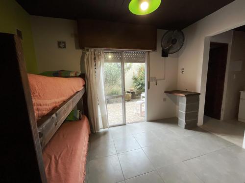 a room with a bedroom with a fireplace and a window at Morada del Sol in San Bernardo