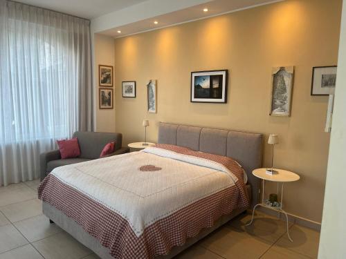 a bedroom with a bed and a chair in it at Villa Varenna in Varenna