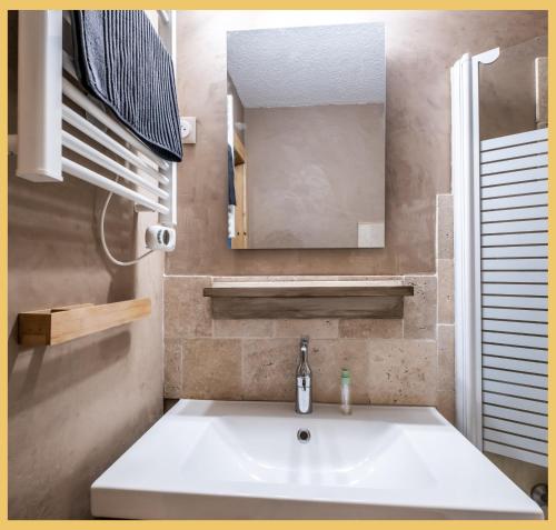a bathroom with a sink and a mirror at L'Alpenlake I Studio I Châtel in Châtel