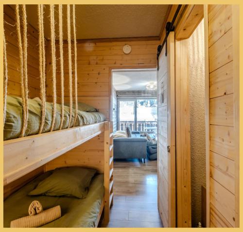 a bedroom with a bunk bed in a log cabin at L'Alpenlake I Studio I Châtel in Châtel