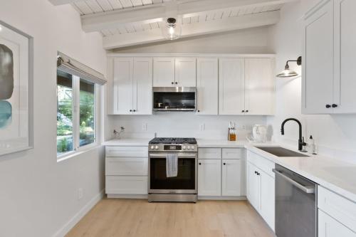 a white kitchen with a stove and a sink at South Lake Chalet by Heavenly in South Lake Tahoe