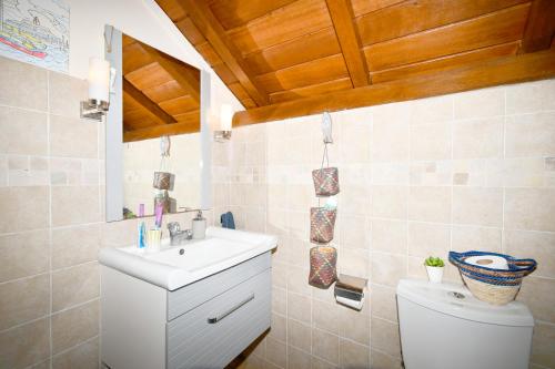 a bathroom with a sink and a toilet at Villa Easternwind in Pointe d'Esny