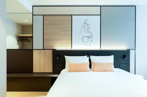 a bedroom with a large white bed with two pillows at Residence Inn by Marriott The Hague in The Hague