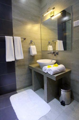 a bathroom with a sink and a mirror at HillCrest Hotel in Kandy