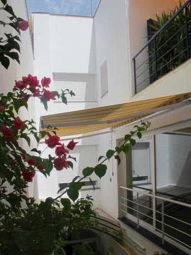 a view of a building with flowers in the foreground at B&B Casa Alfareria 59 in Seville
