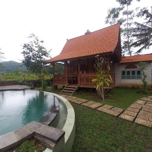 a house with a swimming pool in front of it at Green vanilla Suite 2 in Silebeng
