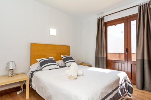 a bedroom with a large white bed and a window at Blue Horizon Coast By PVL in Punta de Mujeres