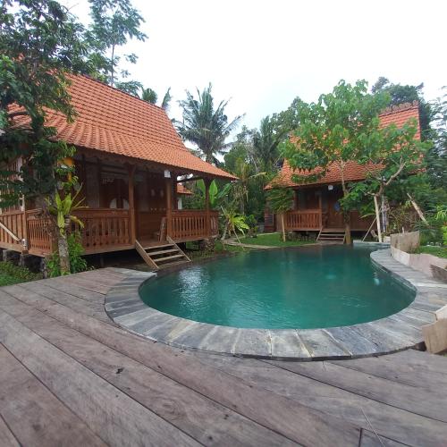a swimming pool in front of a house at Green vanilla Suite 2 in Silebeng