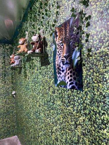 a leopard is sitting on the ground in the grass at Camping estrela Ubatuba in Ubatuba