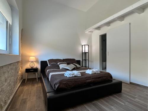 a bedroom with a large bed in a room at Pietre al Sole di Sicilia in Modica