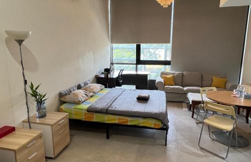 a living room with a bed and a couch at Lumi Tropicana - Unique Stays ! in Kota Damansara