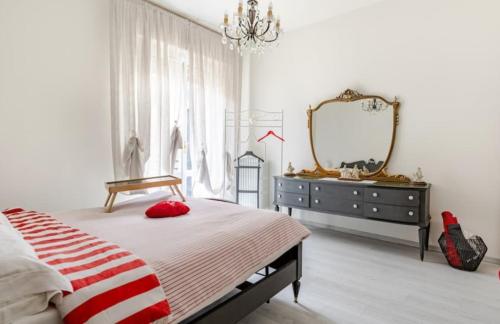 a bedroom with a bed and a dresser and a mirror at Ca`del Fuin in Seregno